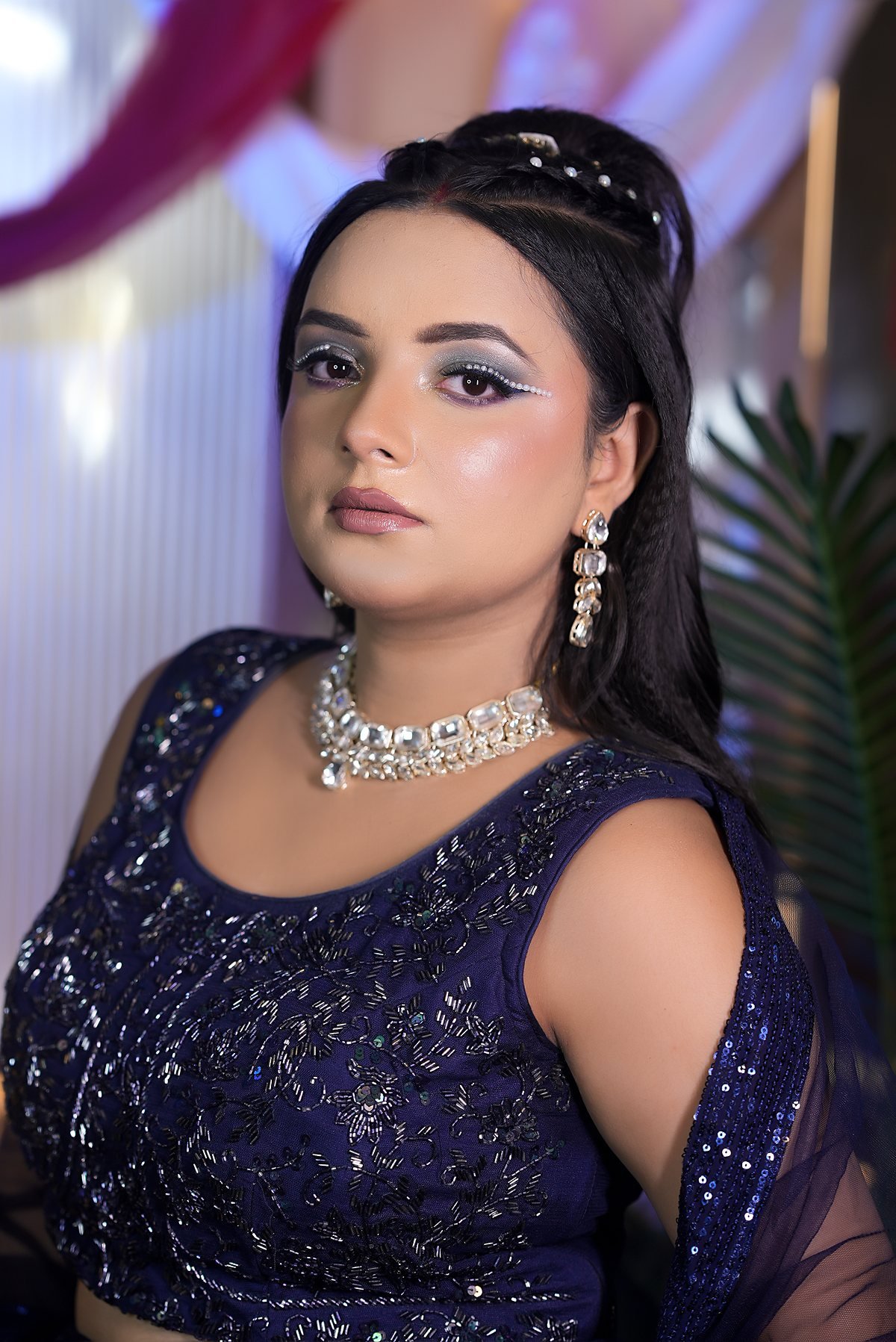 A client in a midnight-blue sequin lehenga with a defined evening eye.