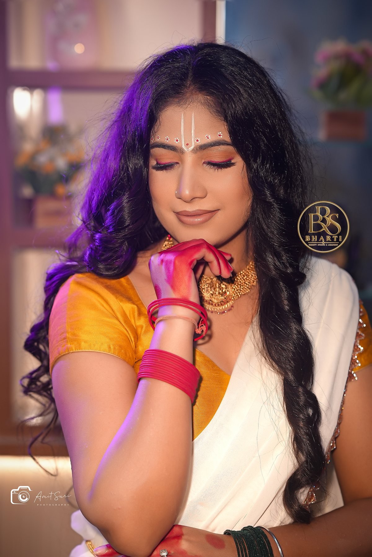 Radha-inspired model styling by Bharti: yellow blouse, ivory saree, devotional forehead detail and floral jewellery.