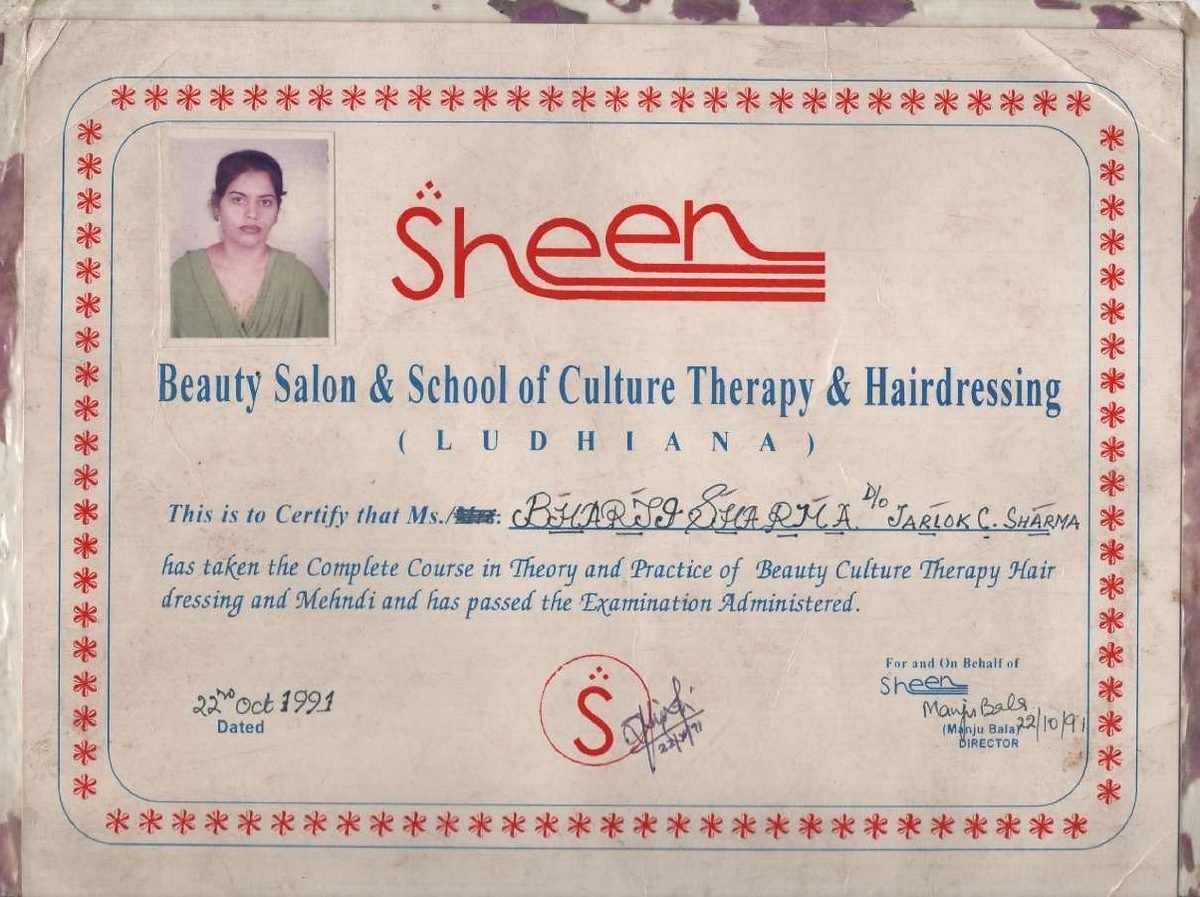 The 1991 Sheen certificate — foxed paper, a stapled photograph, a red asterisk border, dated 22 October 1991.